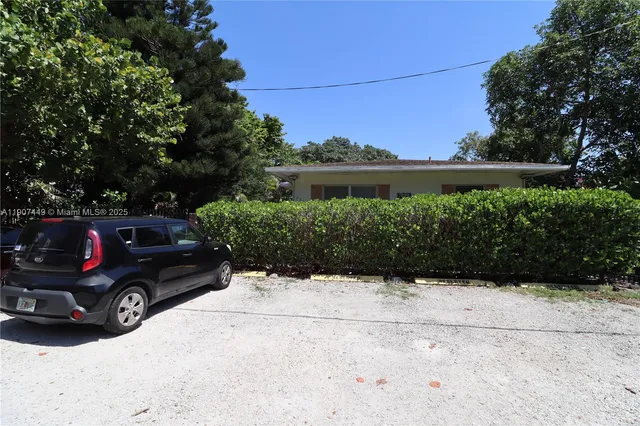 a view of a car parked in front of a house