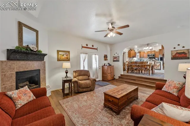 a living room with furniture a flat screen tv and a fireplace