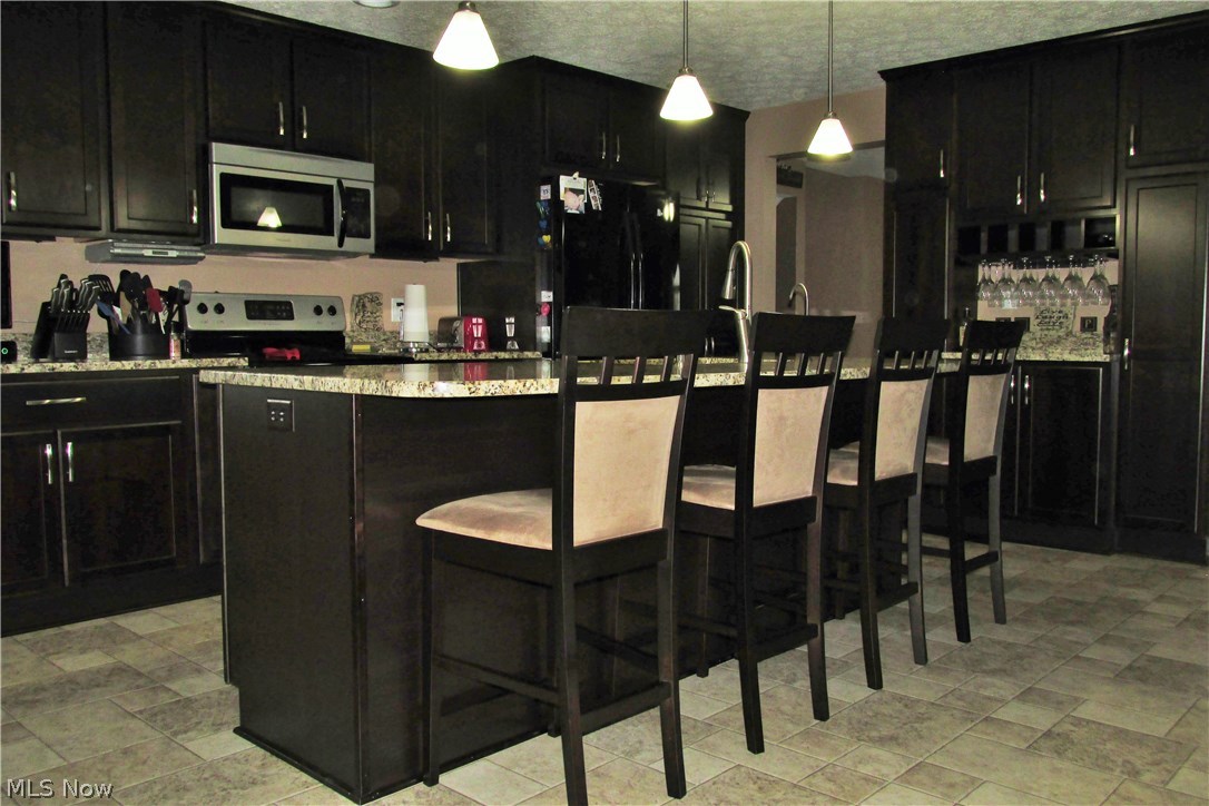 8520 Sterling Road Sterling, OH 44276 - Photo 8 of 35 This amazing newly added chefs dream kitchen has custom cabinets from The Old Parsonage in Ashland providing storage galore along with beautiful granite counter tops for prepping, serving and entertaining!