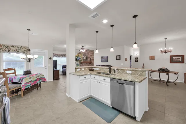 a kitchen with a stove and a white cabinets