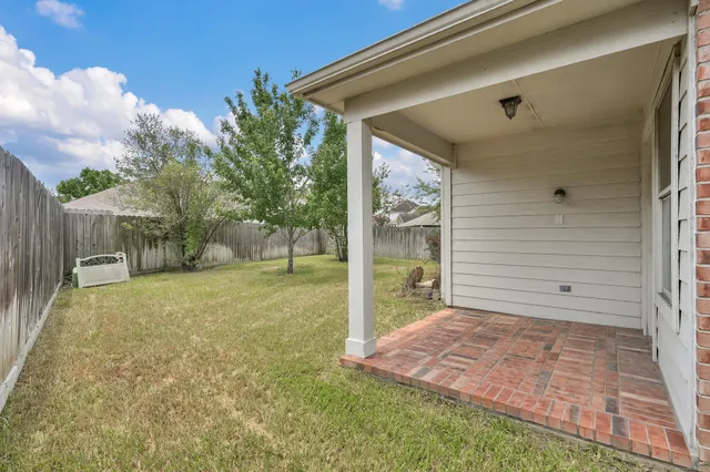 a view of a house with backyard sitting area and garden
