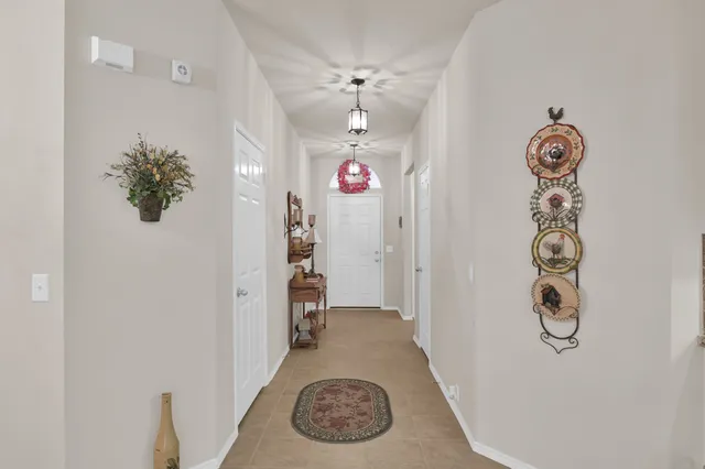 a view of a hallway with workspace and living room