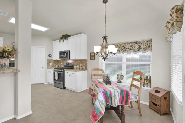 a living room with furniture fireplace and a view of kitchen