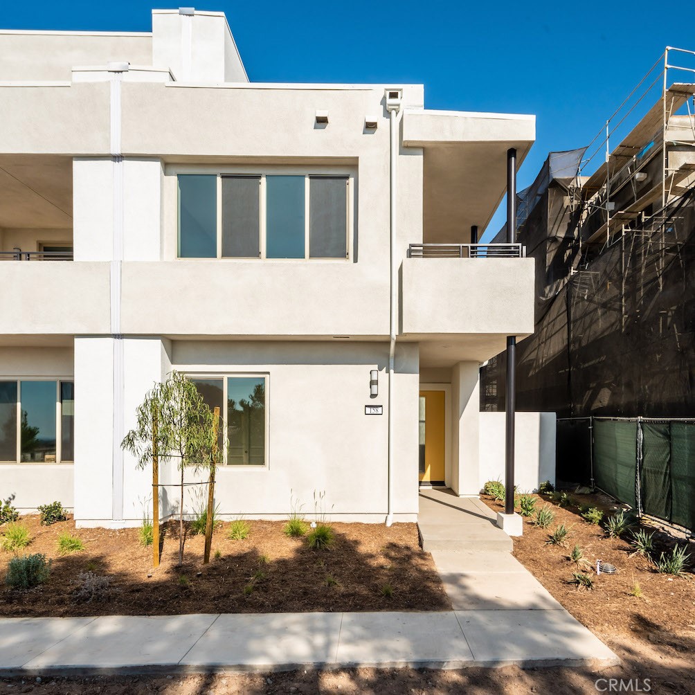 a view of a brick house with large windows