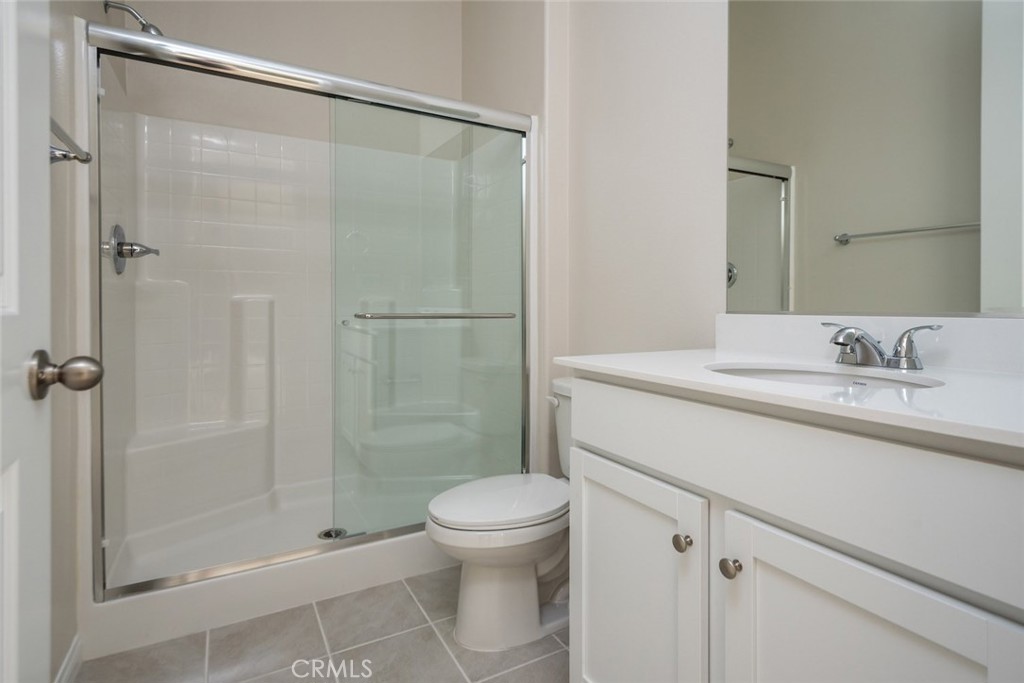 158 Spectacle Irvine, CA 92618 - Photo 15 of 19 a bathroom with a shower sink vanity mirror and toilet