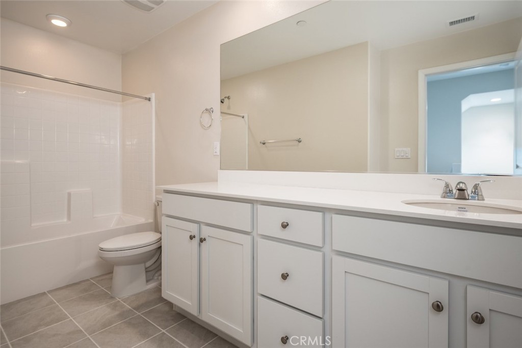 158 Spectacle Irvine, CA 92618 - Photo 16 of 19 a bathroom with a double vanity sink toilet and a tub