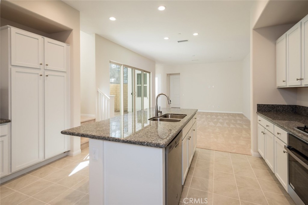 158 Spectacle Irvine, CA 92618 - Photo 3 of 19 a kitchen with granite countertop a sink and a stove