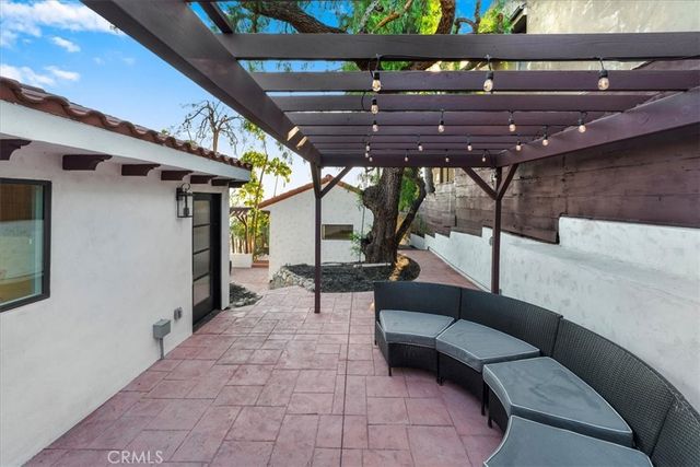 a building outdoor space with patio furniture and potted plants