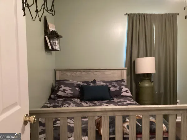 a bed sitting in a bedroom next to a window