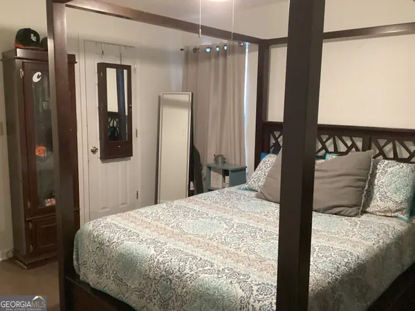 a bedroom with a bed and a mirror