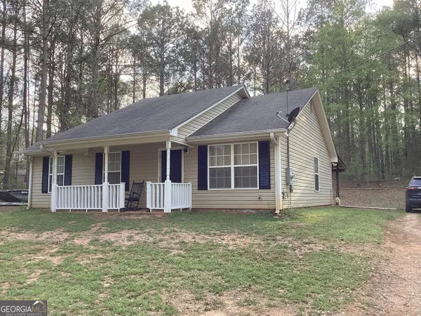 a house that has a tree in front of the house