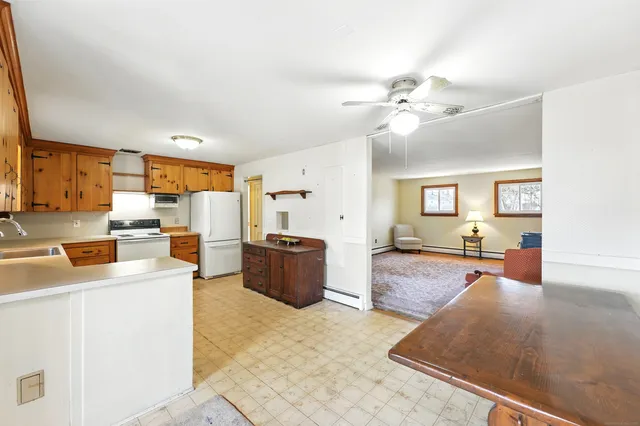 a living room with furniture and a open kitchen view