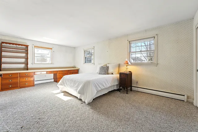 a spacious bedroom with a bed and a couch