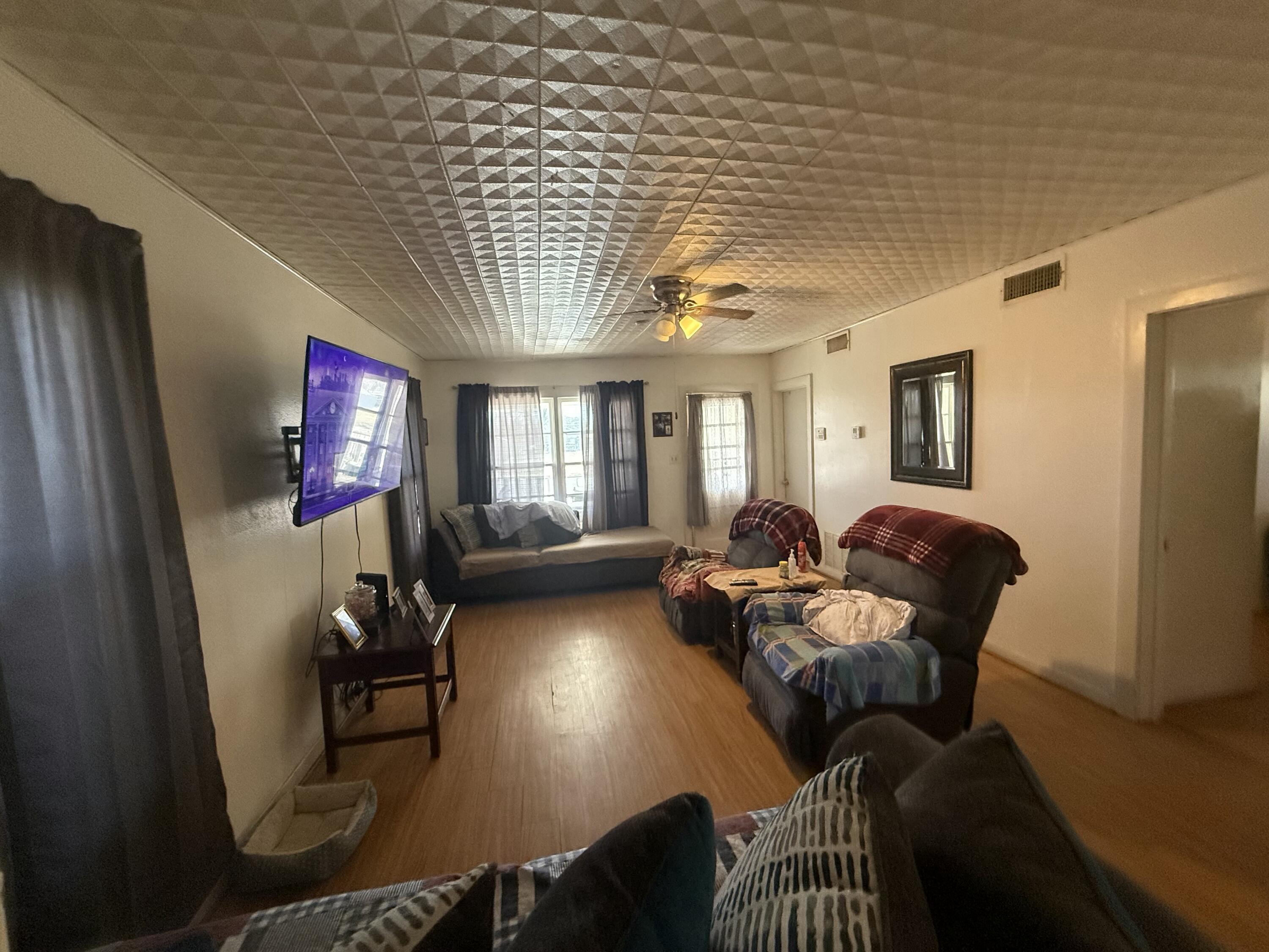Package Package Property Lubbock, TX 79411 - Photo 22 of 107 a living room with furniture windows and a flat screen tv