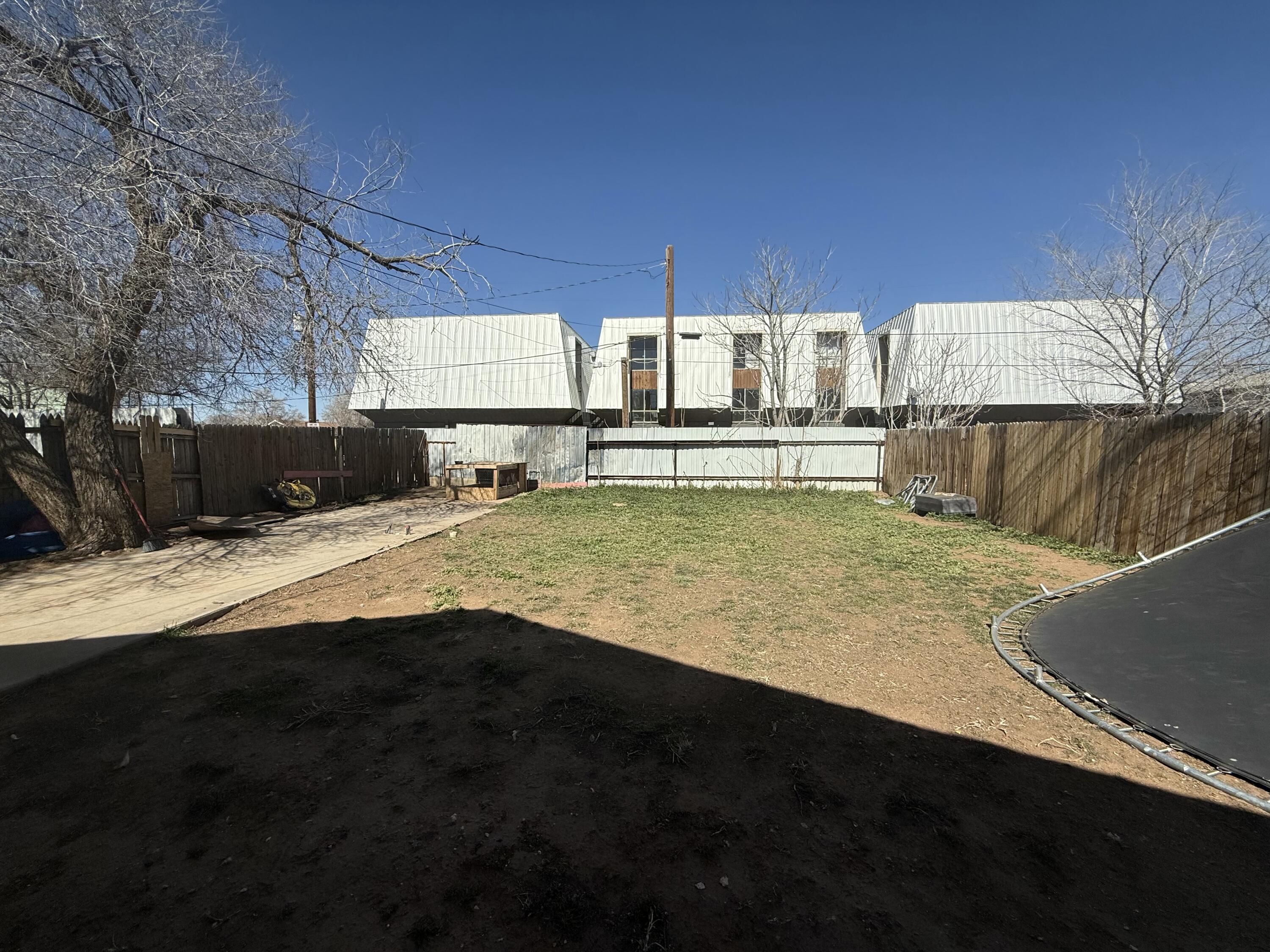Package Package Property Lubbock, TX 79411 - Photo 25 of 107 a view of a swimming pool with a table and chairs under an umbrella