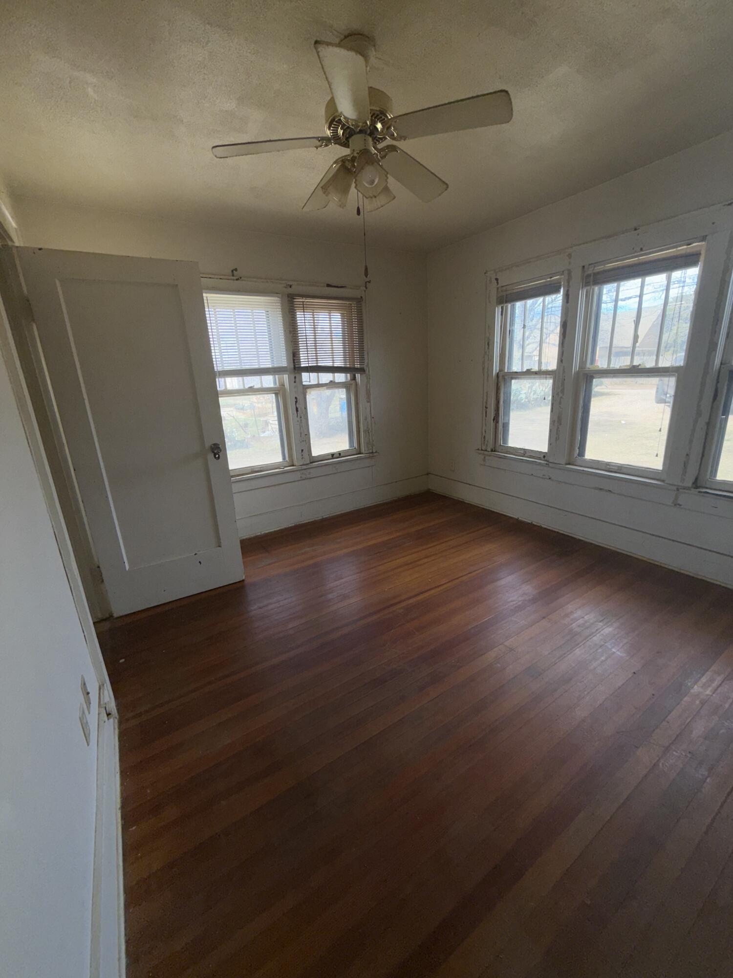 Package Package Property Lubbock, TX 79411 - Photo 57 of 107 an empty room with wooden floor and windows