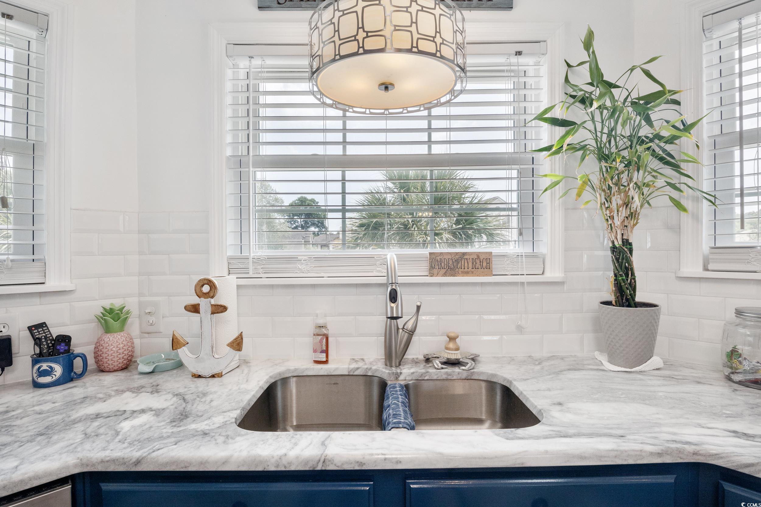 919 Dock Place Murrells Inlet, SC 29576 - Photo 14 of 39 Kitchen with blue cabinetry, tasteful backsplash, and light stone countertops