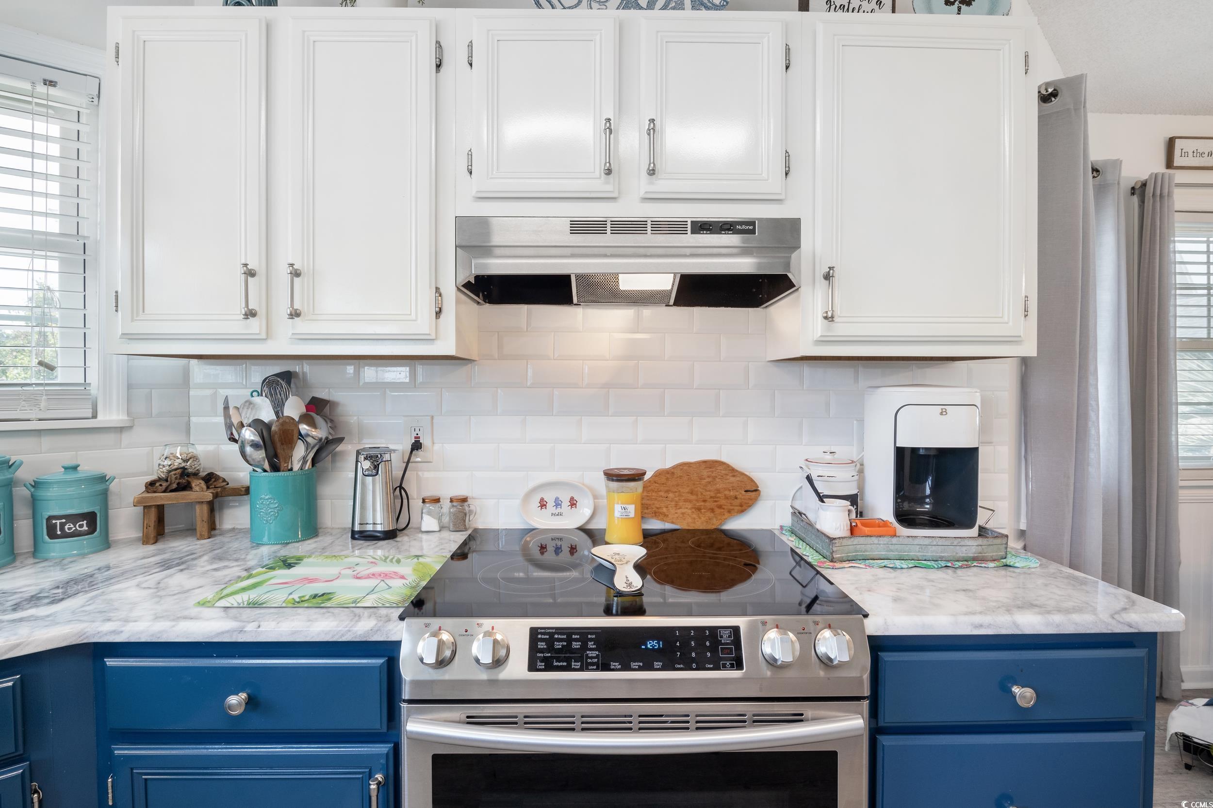 919 Dock Place Murrells Inlet, SC 29576 - Photo 15 of 39 Kitchen featuring stainless steel electric range, under cabinet range hood, blue cabinets, light countertops, and white cabinetry