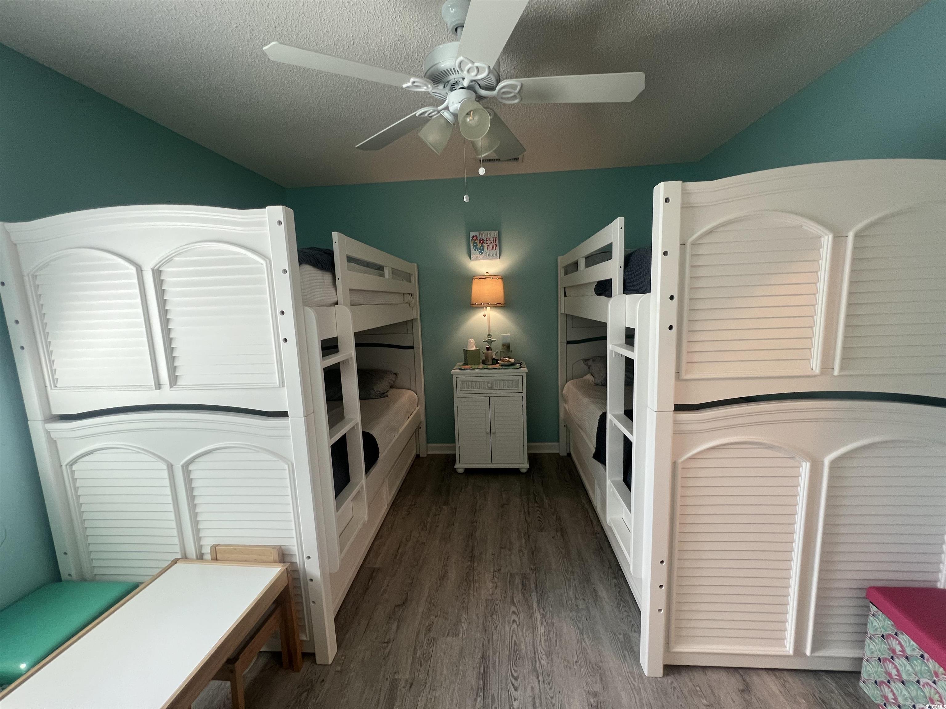 919 Dock Place Murrells Inlet, SC 29576 - Photo 22 of 39 Bedroom featuring wood finished floors, a ceiling fan, and a textured ceiling