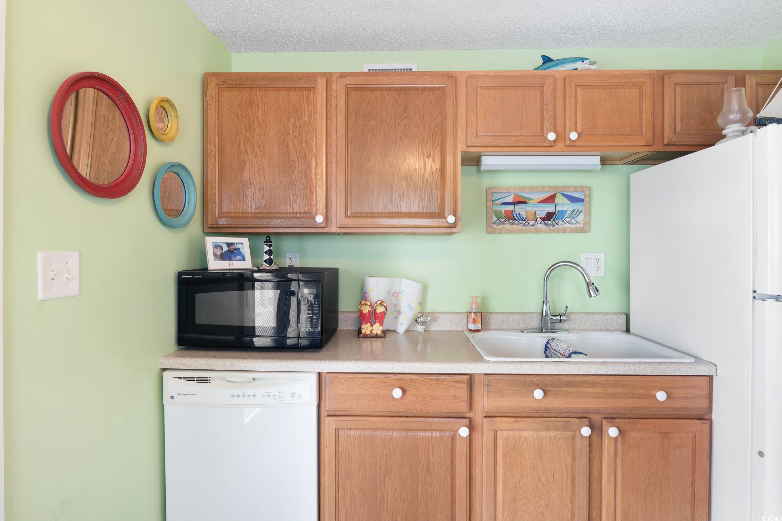 919 Dock Place Murrells Inlet, SC 29576 - Photo 29 of 39 Kitchen featuring white appliances and light countertops