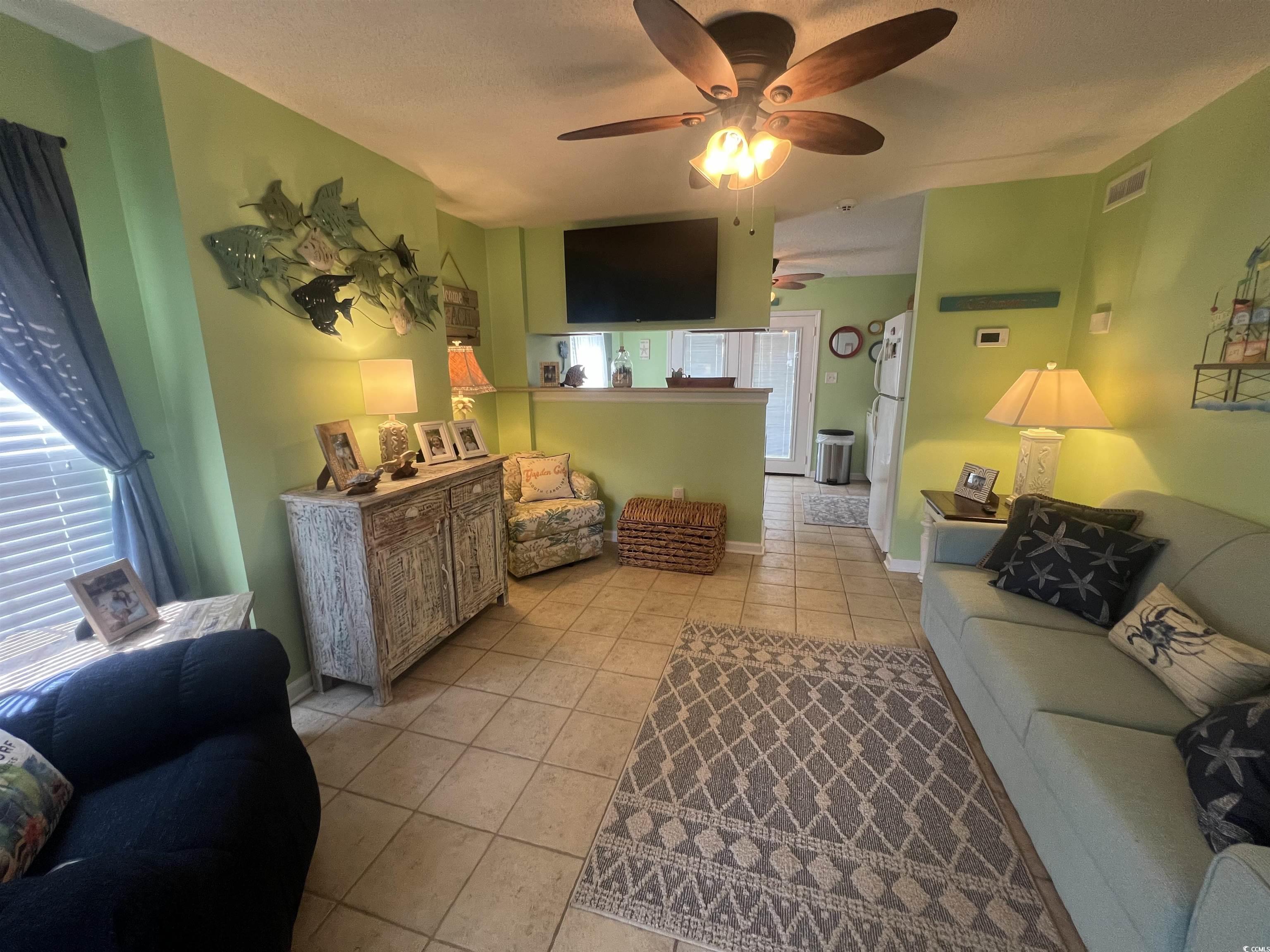 919 Dock Place Murrells Inlet, SC 29576 - Photo 30 of 39 Living area featuring ceiling fan and light tile patterned floors