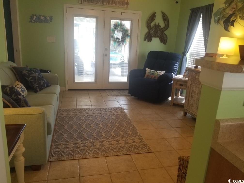 919 Dock Place Murrells Inlet, SC 29576 - Photo 31 of 39 Living room with french doors and light tile patterned floors