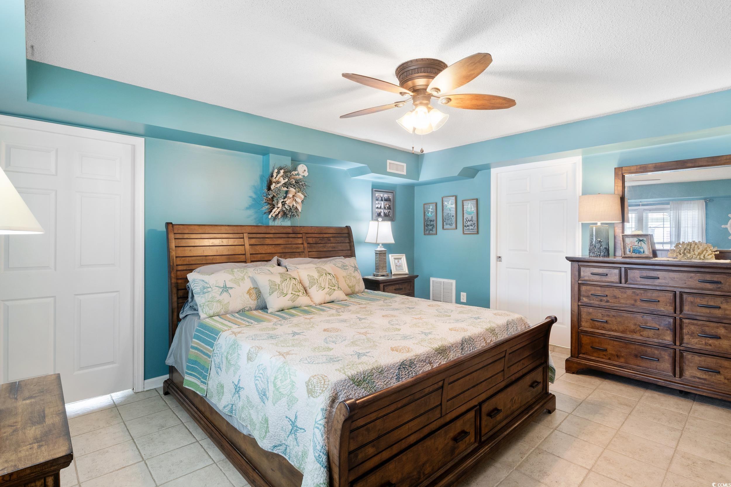 919 Dock Place Murrells Inlet, SC 29576 - Photo 33 of 39 Bedroom with light tile patterned floors and a ceiling fan