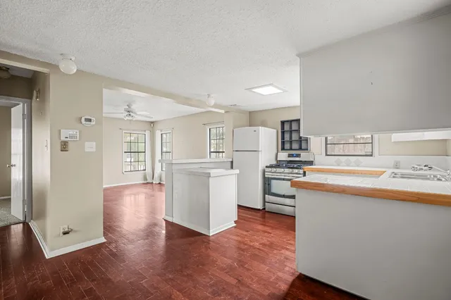 a kitchen with white cabinets and white appliances