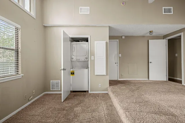 an empty room with windows and closet