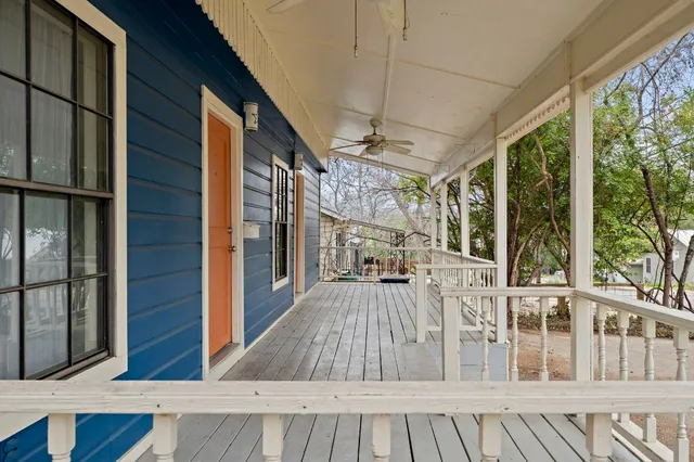 a view of a porch with wooden floor and furniture