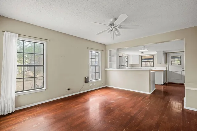 a view of a kitchen with wooden floor and a kitchen