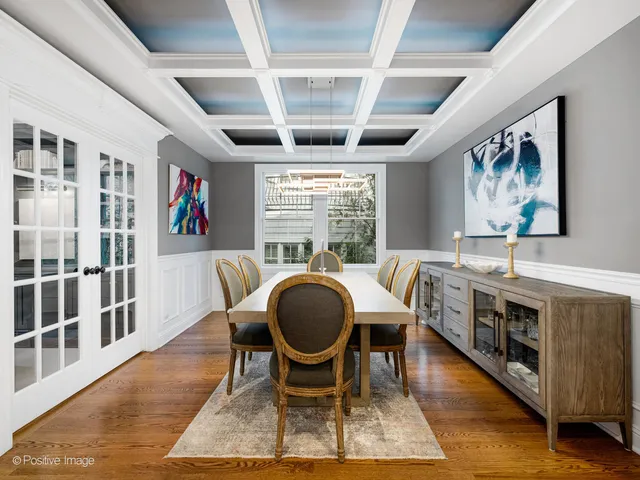 a dining room with furniture a rug and wooden floor