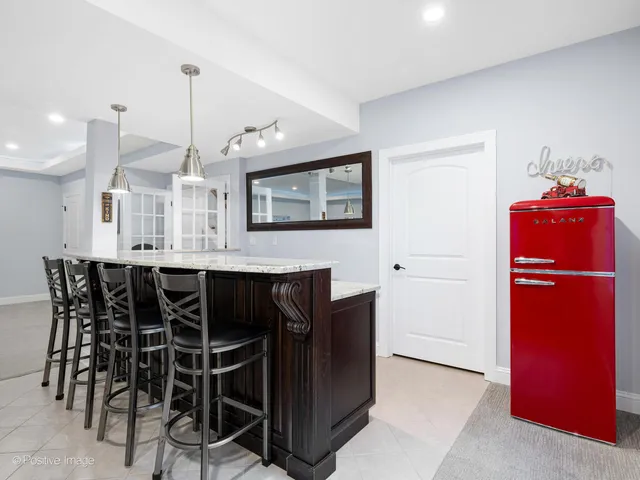 a view of a kitchen with dining room and wooden cabinets