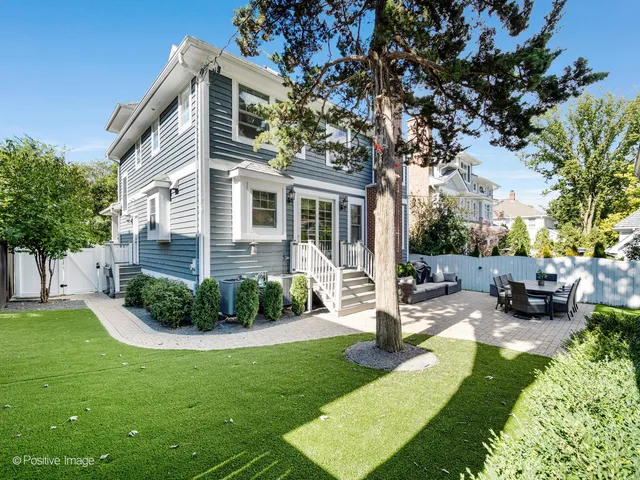 a view of a house with backyard sitting area and garden