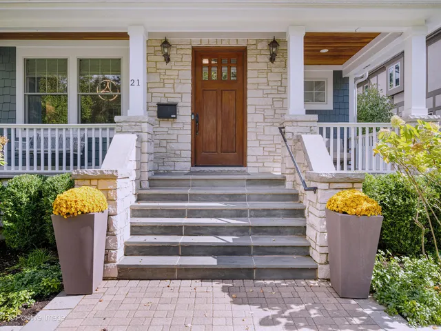 a front view of a house with outdoor seating and plants