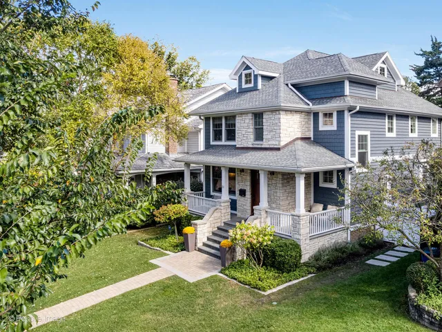 a front view of a house with garden and porch
