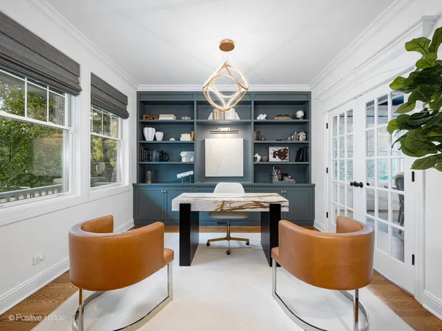a work room with furniture and a chandelier