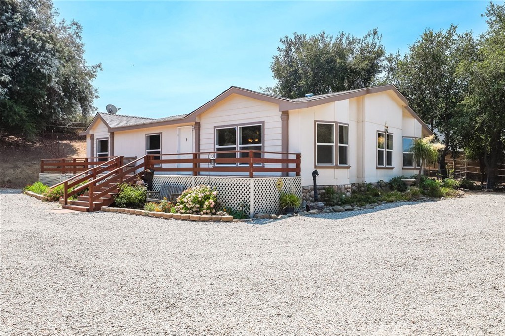 a view of a house with snow on the road
