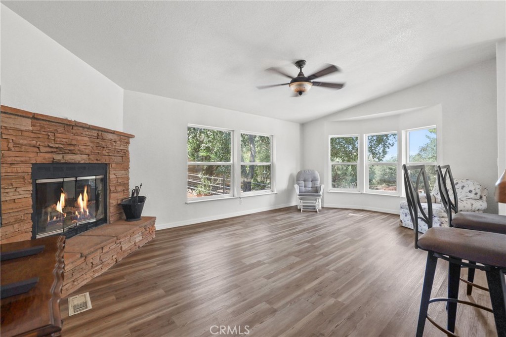 10880 Fox Springs Road Fallbrook, CA 92028 - Photo 11 of 39 a view of a livingroom with furniture a fireplace and wooden floor