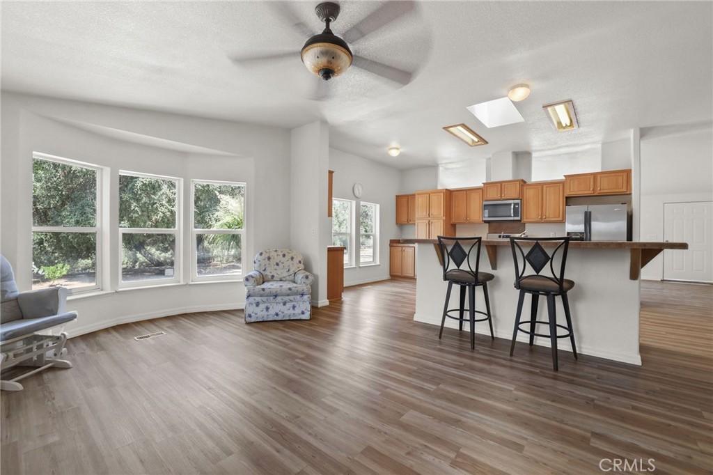 10880 Fox Springs Road Fallbrook, CA 92028 - Photo 12 of 39 a view of a kitchen with dining room and wooden floor