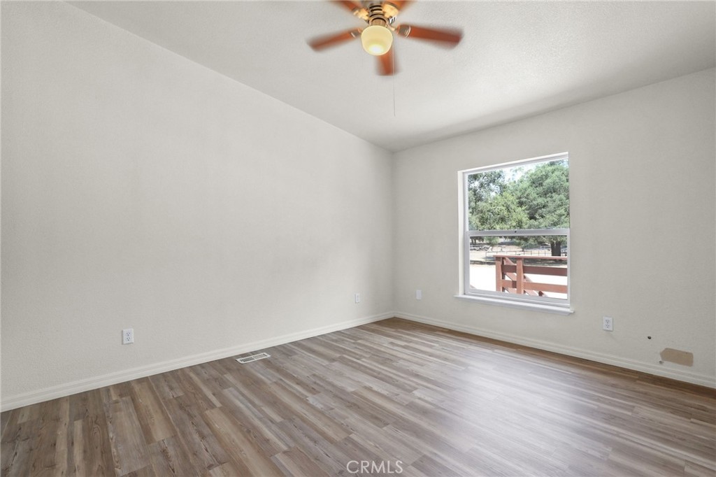 10880 Fox Springs Road Fallbrook, CA 92028 - Photo 21 of 39 an empty room with a window and a fan
