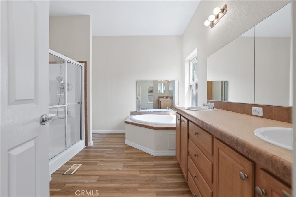 10880 Fox Springs Road Fallbrook, CA 92028 - Photo 26 of 39 a bathroom with a granite countertop sink a toilet a mirror and shower