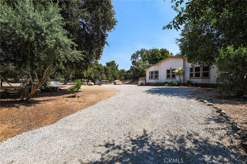 10880 Fox Springs Road Fallbrook, CA 92028 - Photo 30 of 39 a view of the house with a yard