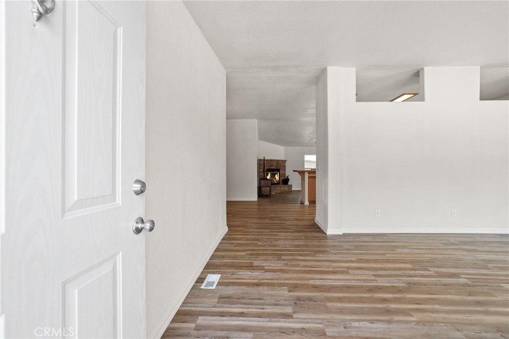 10880 Fox Springs Road Fallbrook, CA 92028 - Photo 6 of 39 a view of a hallway with wooden floor and staircase