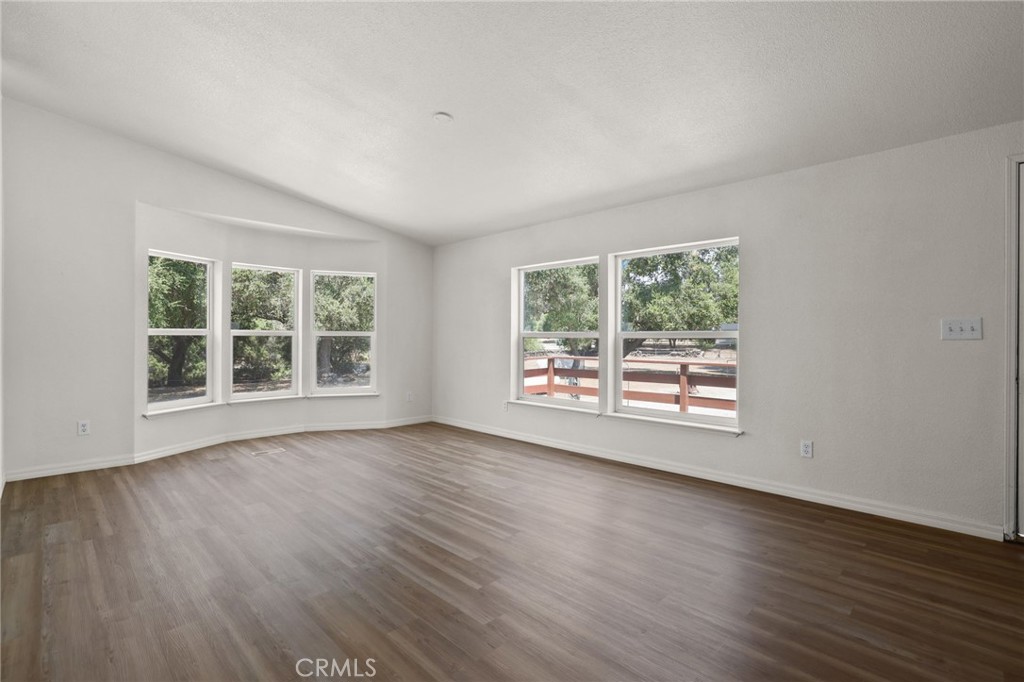 10880 Fox Springs Road Fallbrook, CA 92028 - Photo 9 of 39 a view of an empty room with wooden floor and a window