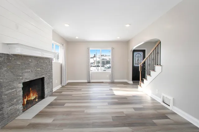 a view of an empty room with window and fireplace