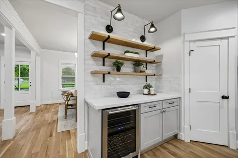 a living room with furniture and kitchen view