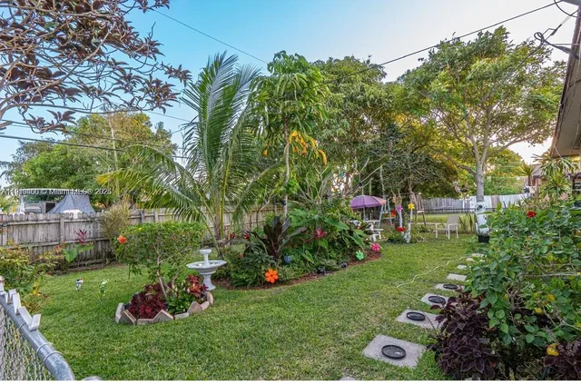 a view of a garden with a house in the background