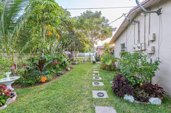 a view of a house with a backyard and garden