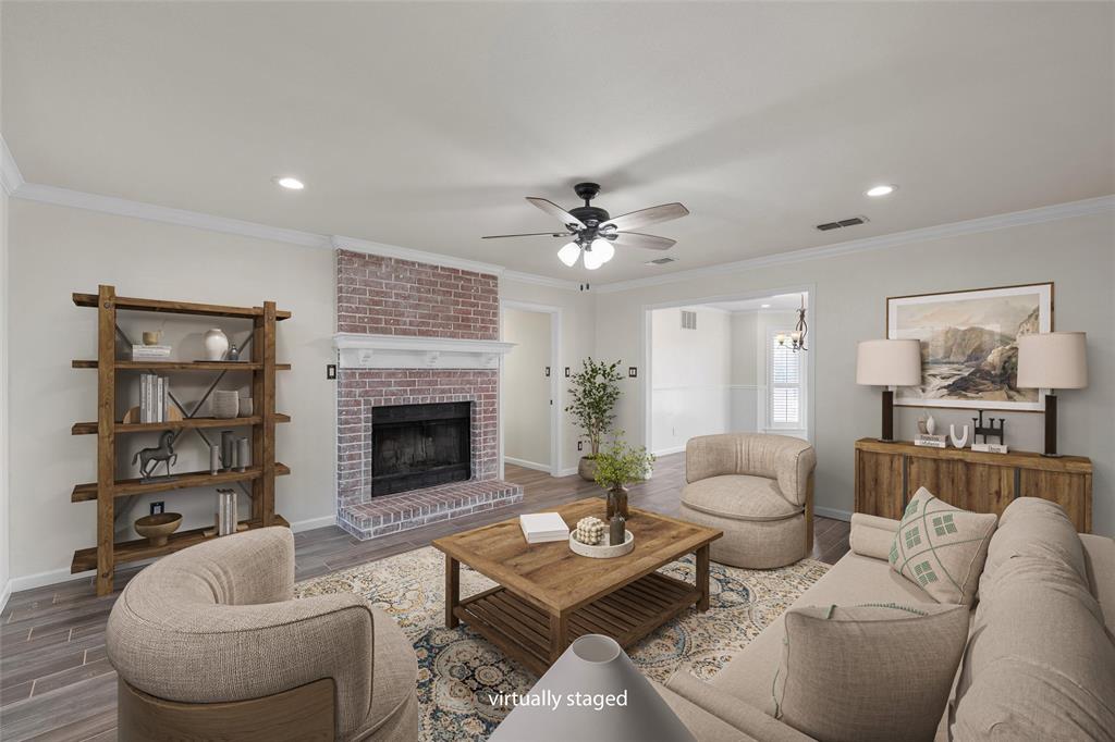 5112 Old Caufield Ranch Road McGregor, TX 76657 - Photo 9 of 38 Living room featuring wood finished floors, ornamental molding, a brick fireplace, a ceiling fan, and recessed lighting